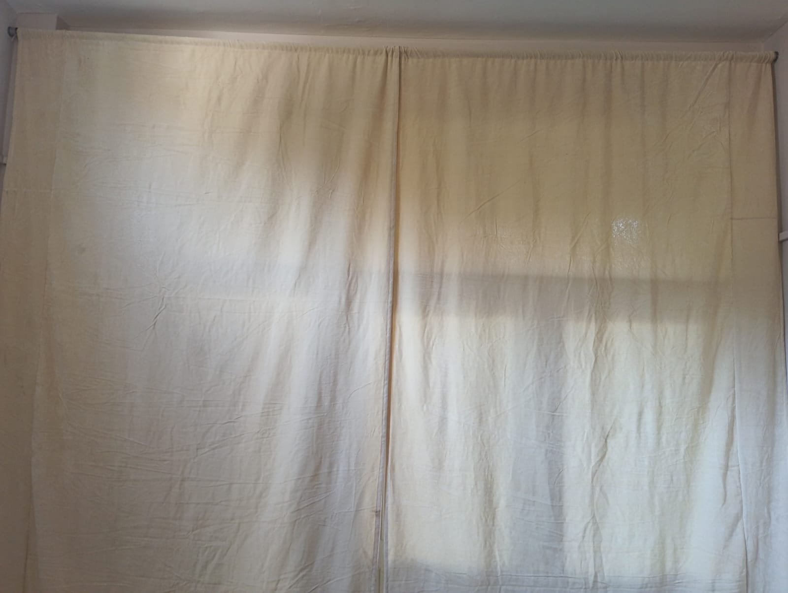 Indoor bamboo window blind with cream fabric backing for complete privacy